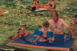 Old image of Head coach in the pool teaching beginners-1
